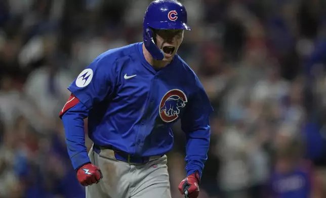 Chicago Cubs' Pete Crow-Armstrong reacts after hitting a grand slam to right field during the seventh inning of a baseball game against the Cincinnati Reds, Friday, May 23, 2025, in Cincinnati. (AP Photo/Carolyn Kaster)