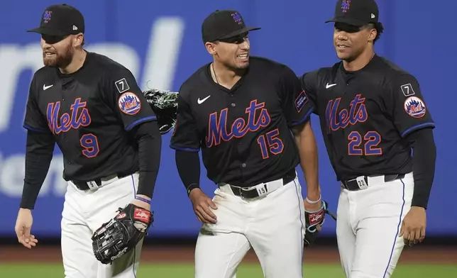 New York Mets' Tyrone Taylor (15) celebrates with teammates Brandon Nimmo (9) and Juan Soto (22) after a baseball game against the Chicago Cubs Friday, May 9, 2025, in New York. (AP Photo/Frank Franklin II)