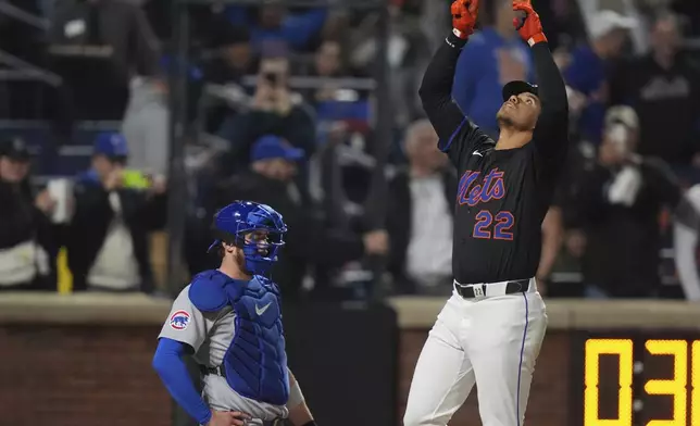 New York Mets' Juan Soto (22) gestures as he passes Chicago Cubs catcher Carson Kelly after hitting a home run during the fourth inning of a baseball game Friday, May 9, 2025, in New York. (AP Photo/Frank Franklin II)