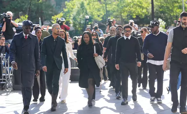Family and supporters of Sean "Diddy" Combs, including his sons Quincy Brown, second from left, and Justin Combs, third from right, arrive to the courthouse in New York, Monday, May 12, 2025. (AP Photo/Seth Wenig)