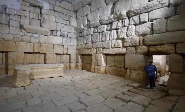 A worker stands on a dry reservoir of the Ein el-Fijeh spring, in the Barada Valley, Syria, Thursday, May 8, 2025. The Ein el-Fijeh spring, the main water source for Damascus, has nearly dried up, forcing many residents in the capital and its suburbs to rely on water delivered by tanker trucks that fill from local wells. (AP Photo/Omar Sanadiki)