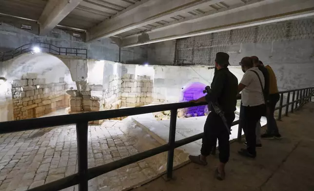 Visitors watch the dry main reservoir of the spring in Ein el-Fijeh, Barada Valley, Syria, Thursday, May 8, 2025. The Ein el-Fijeh spring, the main source of water for Damascus, is almost dry and many people in the capital and its suburbs are now relying on buying water from tanker trucks that fill from wells. (AP Photo/Omar Sanadiki)