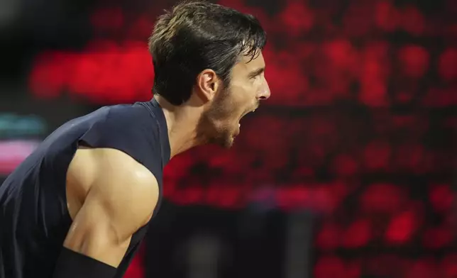 Italy's Lorenzo Musetti reacts winning the quarter-final tennis match against Germany's Alexander Zverev at the Italian Open in Rome, Italy, Wednesday, May 14, 2025. (AP Photo/Alessandra Tarantino)