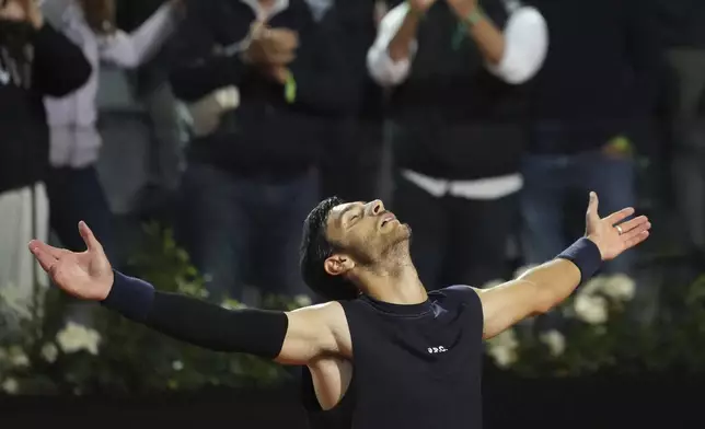Italy's Lorenzo Musetti reacts winning the quarter-final tennis match against Germany's Alexander Zverev at the Italian Open in Rome, Italy, Wednesday, May 14, 2025. (AP Photo/Alessandra Tarantino)