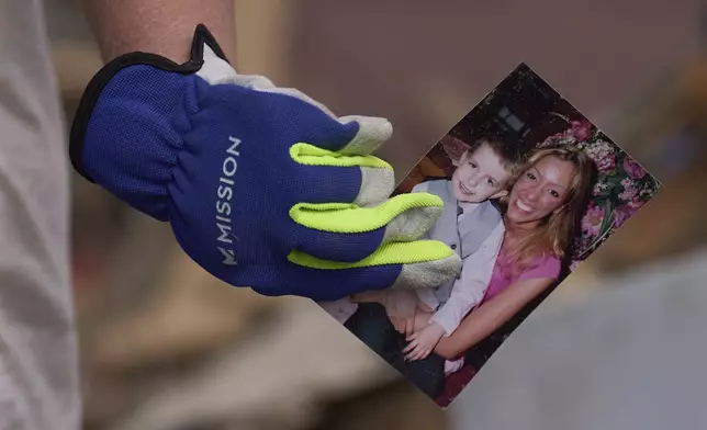 Edwina Wilson holds a photo she found in what is left of her destroyed home, Sunday, May 18, 2025, in London, Ky., after a severe storm passed through the area. (AP Photo/Carolyn Kaster)