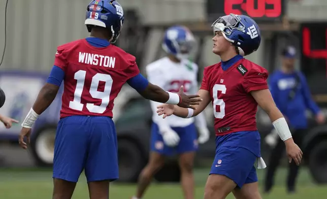 New York Giants quarterbacks Jameis Winston, left, greets Jaxson Dart during an NFL football practice in East Rutherford, N.J., Wednesday, May 28, 2025. (AP Photo/Seth Wenig)