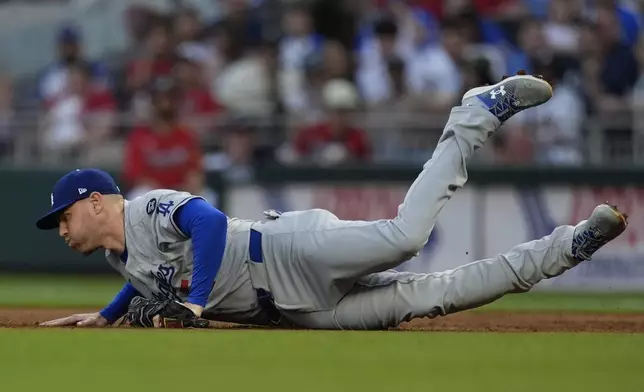 Los Angeles Dodgers first baseman Freddie Freeman (5) makes a catch off the Atlanta Braves in the third inning of a baseball game, Friday, May 2, 2025, in Atlanta. (AP Photo/Mike Stewart)