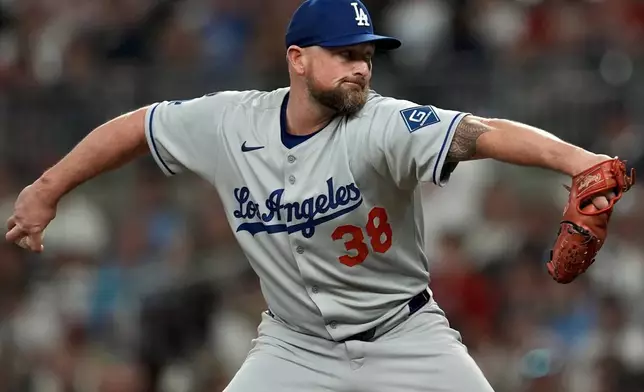 Los Angeles Dodgers pitcher Kirby Yates (38) delivers against the Atlanta Braves in the seventh inning of a baseball game, Friday, May 2, 2025, in Atlanta. (AP Photo/Mike Stewart)