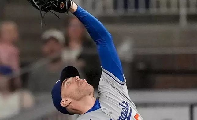 Los Angeles Dodgers first baseman Freddie Freeman (5) makes the catch against Atlanta Braves' Nick Allen in the nineth inning of a baseball game, Friday, May 2, 2025, in Atlanta. (AP Photo/Mike Stewart)