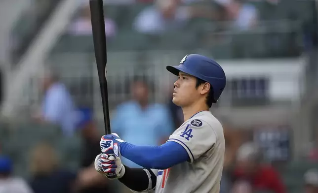 Los Angeles Dodgers two-way player Shohei Ohtani (17) prepares to bat against the Atlanta Braves in the first inning of a baseball game, Friday, May 2, 2025, in Atlanta. (AP Photo/Mike Stewart)