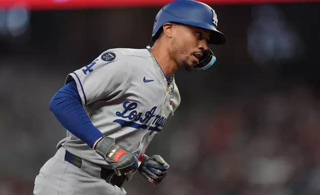 Los Angeles Dodgers' Mookie Betts (50) celebrates his solo homer against the Atlanta Braves in the sixth inning of a baseball game, Friday, May 2, 2025, in Atlanta. (AP Photo/Mike Stewart)