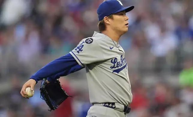 Los Angeles Dodgers pitcher Yoshinobu Yamamoto (18) reacts after cathing a ball hit by Atlanta Braves' Sean Murphy in the X inning of a baseball game, Friday, May 2, 2025, in Atlanta. (AP Photo/Mike Stewart)