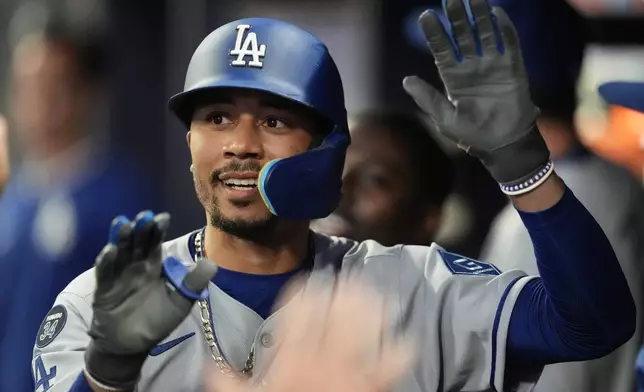 Los Angeles Dodgers' Mookie Betts (50) celebrates his solo homer against the Atlanta Braves in the sixth inning of a baseball game, Friday, May 2, 2025, in Atlanta. (AP Photo/Mike Stewart)