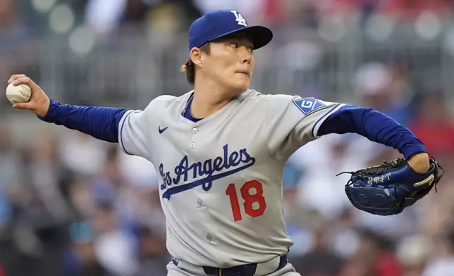 Los Angeles Dodgers pitcher Yoshinobu Yamamoto (18) works against the Atlanta Braves in the first inning of a baseball game, Friday, May 2, 2025, in Atlanta. (AP Photo/Mike Stewart)