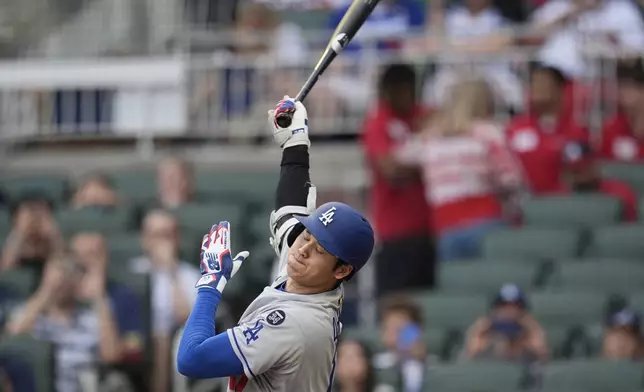 Los Angeles Dodgers two-way player Shohei Ohtani (17) strikes out against the Atlanta Braves in the first inning of a baseball game, Friday, May 2, 2025, in Atlanta. (AP Photo/Mike Stewart)
