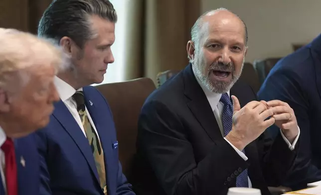 Commerce Secretary Howard Lutnick speaks during a cabinet meeting at the White House, Wednesday, April 30, 2025, in Washington, as President Donald Trump and Secretary of Defense, Pete Hegseth, look on. (AP Photo/Evan Vucci)