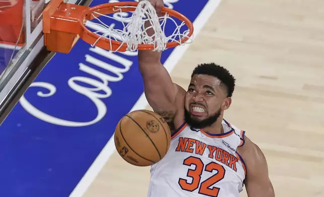 New York Knicks center Karl-Anthony Towns (32) scores against the Indiana Pacers during the fourth quarter of Game 5 of the NBA basketball Eastern Conference final, Thursday, May 29, 2025, in New York. (AP Photo/Adam Hunger)