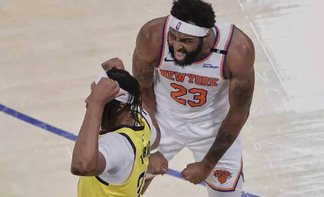 New York Knicks center Mitchell Robinson (23) reacts during the third quarter of Game 5 of the NBA basketball Eastern Conference finals against the Indiana Pacers, Thursday, May 29, 2025, in New York. (AP Photo/Adam Hunger)