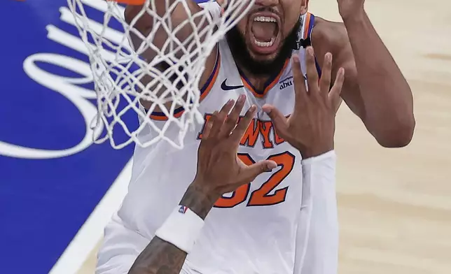 New York Knicks center Karl-Anthony Towns (32) scores against Indiana Pacers guard Bennedict Mathurin (00) during the fourth quarter of Game 5 of the NBA basketball Eastern Conference final, Thursday, May 29, 2025, in New York. (AP Photo/Adam Hunger)