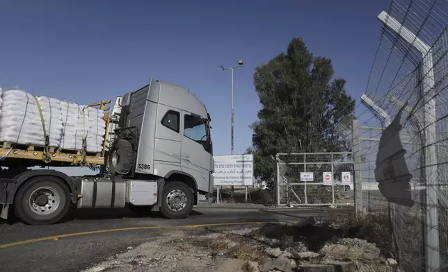 A truck carrying humanitarian aid for the Gaza Strip enters to Kerem Shalom Crossing in southern Israel, Tuesday May 20, 2025. (AP Photo/Maya Alleruzzo)