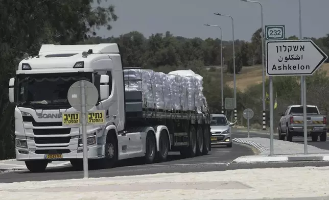 A truck loaded with humanitarian aid for the Gaza Strip makes its way to the Kerem Shalom crossing in southern Israel, in Israel-Gaza border, Tuesday, May 20, 2025. (AP Photo/Maya Alleruzzo)