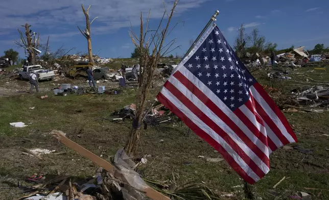 An American Flag is posted near destroyed homes, Sunday, May 18, 2025, in London, Ky., after a severe storm passed through the area. (AP Photo/Carolyn Kaster)