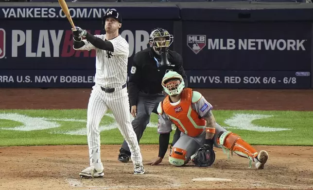 New York Mets catcher Francisco Alvarez, right, watches New York Yankees' Cody Bellinger follows through on a grand slam during the eighth inning of a baseball game Sunday, May 18, 2025, in New York. (AP Photo/Frank Franklin II)