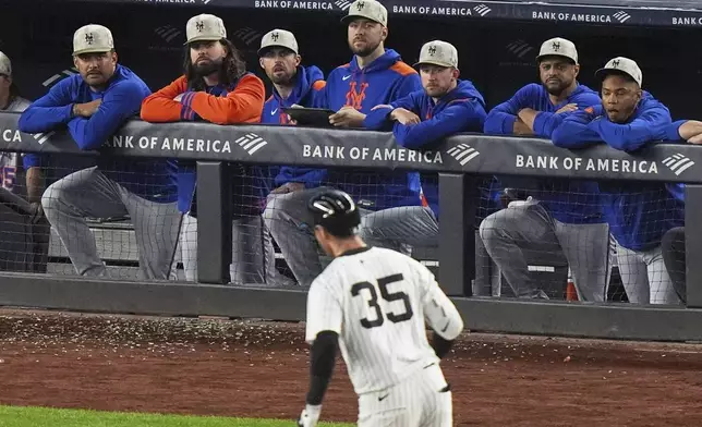 New York Mets players watch as New York Yankees' Cody Bellinger (35) runs the bases after hitting a grand slam home run during the eighth inning of a baseball game Sunday, May 18, 2025, in New York. (AP Photo/Frank Franklin II)