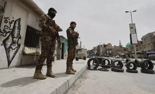 Syrian government security forces stand guard on their checkpointat one of Jaramana suburb entrances, after clashes in the area between members of the minority Druze sect and pro-government fighters, in the southern suburb of Jaramana, Damascus, Syria, Wednesday, April 30, 2025. (AP Photo/Omar Sanadiki)