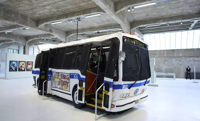 The Bus by Red Grooms is seen at the Fenix Migration Museum in Rotterdam, Netherlands, Wednesday, May 14, 2025. (AP Photo/Peter Dejong)