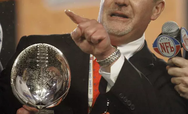FILE - Indianapolis Colts owner Jim Irsay holds the Vince Lombardi Trophy after the Colts defeated the Chicago Bears 29-17 in the Super Bowl XLI football game at Dolphin Stadium in Miami, Sunday, Feb. 4, 2007. (AP Photo/David J. Phillip, File)