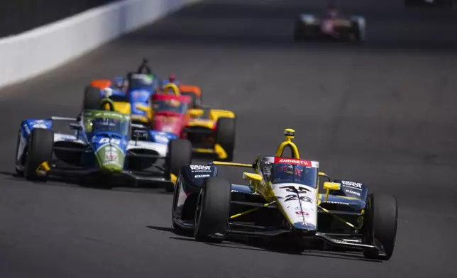 Colton Herta drives into the first turn during practice for the Indianapolis 500 auto race at Indianapolis Motor Speedway in Indianapolis, Friday, May 23, 2025. (AP Photo/Michael Conroy)