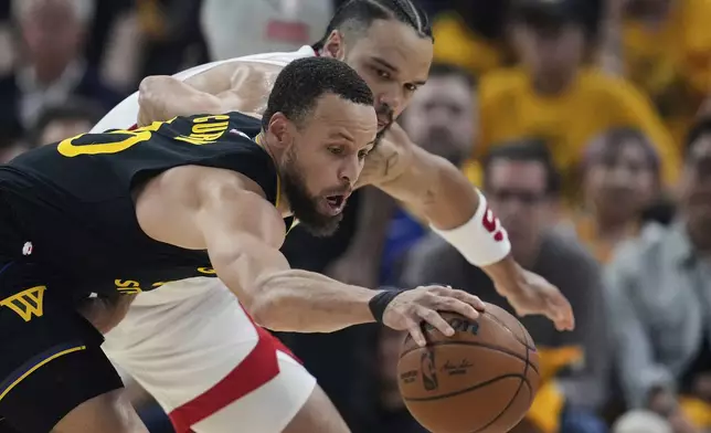 Golden State Warriors guard Stephen Curry, left, takes the ball away from Houston Rockets forward Dillon Brooks during the first half of Game 6 of an NBA basketball first-round playoff series Friday, May 2, 2025, in San Francisco. (AP Photo/Godofredo A. Vásquez)