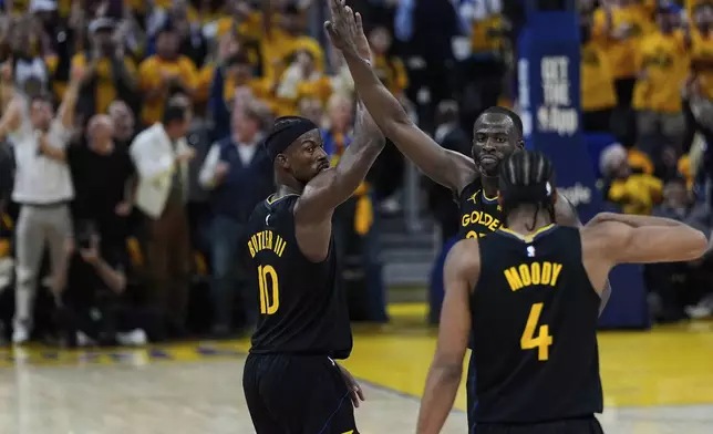Golden State Warriors forward Jimmy Butler III (10) celebrates with Golden State Warriors forward Draymond Green (23) after scoring during the first half of Game 6 of an NBA basketball first-round playoff series against the Houston Rockets, Friday, May 2, 2025, in San Francisco. (AP Photo/Godofredo A. Vásquez)