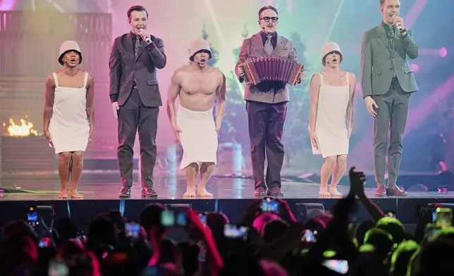 Swedish Eurovision competitor KAJ from Finland, Kevin Holmstrom, Jakob Norrgard and Axel Ahman, perform their sauna song during their semifinal during the 69th Eurovision Song Contest, in Basel, Switzerland, Tuesday, May 13, 2025. (AP Photo/Martin Meissner)