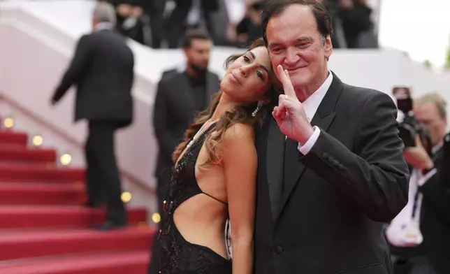 Daniella Pick, left, and Quentin Tarantino pose for photographers upon arrival at the premiere of the film 'Nouvelle Vague' at the 78th international film festival, Cannes, southern France, Saturday, May 17, 2025. (AP Photo/Natacha Pisarenko)