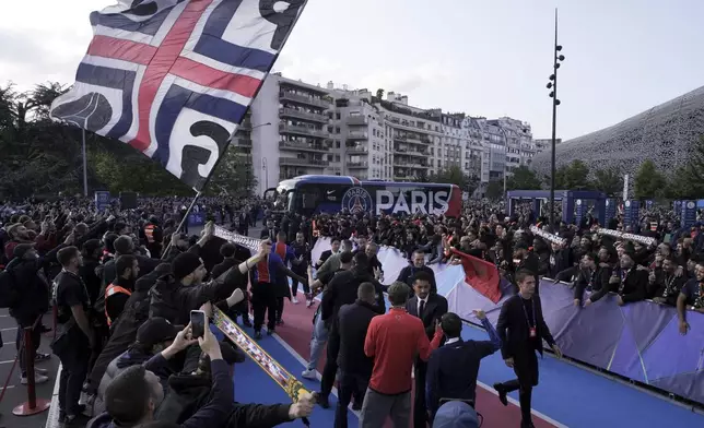 Fans welcome PSG players ahead of the Champions League semifinal, second leg soccer match between Paris Saint-Germain and Arsenal at the Parc des Princes in Paris, Wednesday, May 7, 2025. (AP Photo/Aurelien Morissard)