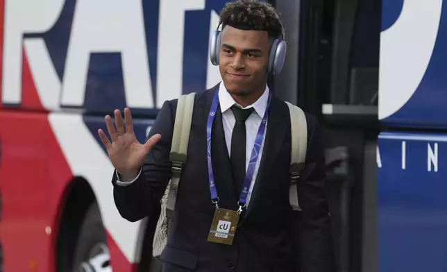 PSG's Desire Doue greets fans as he arrives for the Champions League semifinal, second leg soccer match between Paris Saint-Germain and Arsenal at the Parc des Princes in Paris, Wednesday, May 7, 2025. (AP Photo/Thibault Camus)