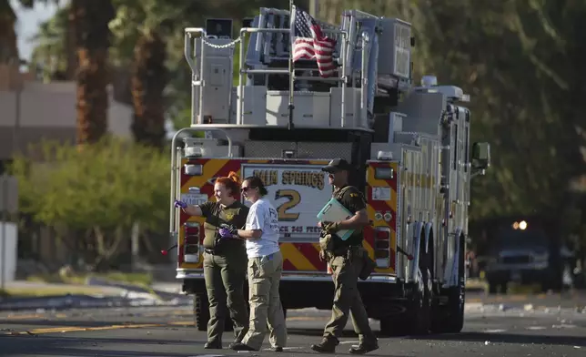 Investigators walk the on the scene of an explosion Saturday, May 17, 2025, in Palm Springs, Calif. (AP Photo/Eric Thayer)