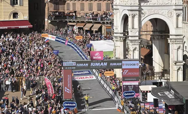Wout Van Aert of Team Visma | Lease A Bike celebrates as he cycles to the finish line to win the stage 9 of the Giro d'Italia from Gubbio to Siena, Italy, Sunday, May 18, 2025. (Matteo Secci/LaPresse via AP)