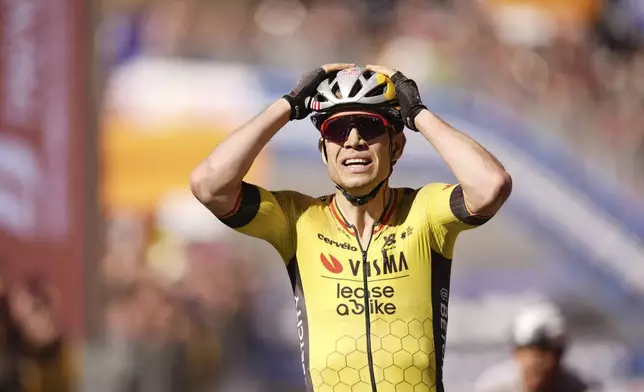 Wout Van Aert Wout of Team Visma | Lease A Bike celebrates as he cycles to the finish line to win the stage 9 of the Giro d'Italia from Gubbio to Siena, Italy, Sunday, May 18, 2025. (Fabio Ferrari/LaPresse via AP)