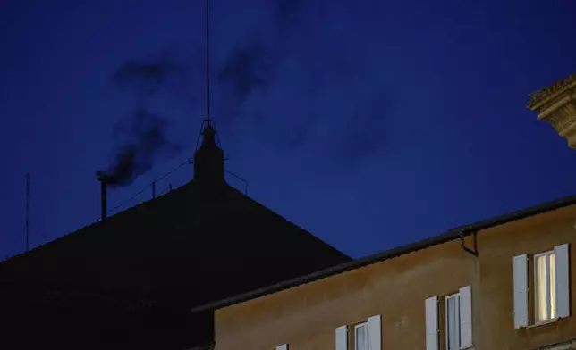 Black smoke billows from the chimney of the Sistine Chapel, where 133 cardinals are gathering on the first day of the conclave, indicating that a successor of late Pope Francis was not elected, Wednesday, May 7, 2025. (AP Photo/Bernat Armangue)