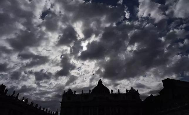 Clouds pass over St Peter's Basilica during the cardinals' conclave to elect a new pope, at the Vatican, Wednesday, May 7, 2025. (AP Photo/Bernat Armangue)