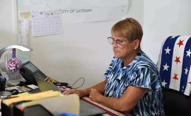 Cheryl Tillman, mayor of Gateway, Ark., and sister of James Appleton, who was fatally shot in 2017, works on her laptop at Town Hall on May 28, 2026. Grant Hardin, who briefly served as police chief, pleaded guilty to first-degree murder. (AP Photo/Nick Ingram)