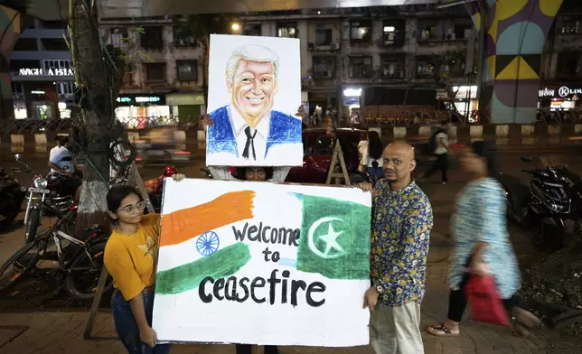 Students of an art school and their teacher carry a hand-drawn portrait of the US President Donald Trump as they celebrate the ceasefire between India and Pakistan, in Mumbai, India, Saturday, May 10, 2025. (AP Photo/Rajanish Kakade)
