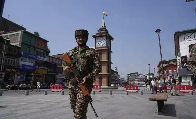 An Indian soldier patrols as he guard near a clock tower day after the ceasefire between Indian and Pakistan in Srinagar, in Indian controlled Kashmir, Sunday, May 11, 2025.(AP Photo/Mukhtar Khan)