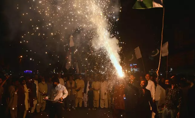 People light fireworks to celebrate Pakistan and India reaching a ceasefire deal, during a demonstration in Hyderabad, Pakistan, Saturday, May 10, 2025. (AP Photo/Pervez Masih)