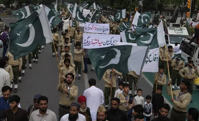 People with national flags take part in a rally to show solidarity with Pakistan Army, a day after the ceasefire between Indian and Pakistan was announced, in Lahore, Pakistan, Sunday, May 11, 2025. (AP Photo/K.M. Chaudary)