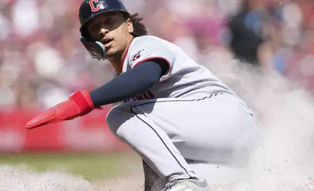 Cleveland Guardians' Bo Naylor scores on a single hit by Carlos Santana during the seventh inning of a baseball game against the Cincinnati Reds, Sunday, May 18, 2025, in Cincinnati. (AP Photo/Jeff Dean)