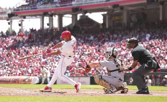 Cincinnati Reds' Will Benson hits a single during the second inning of a baseball game against the Cleveland Guardians, Sunday, May 18, 2025, in Cincinnati. (AP Photo/Jeff Dean)